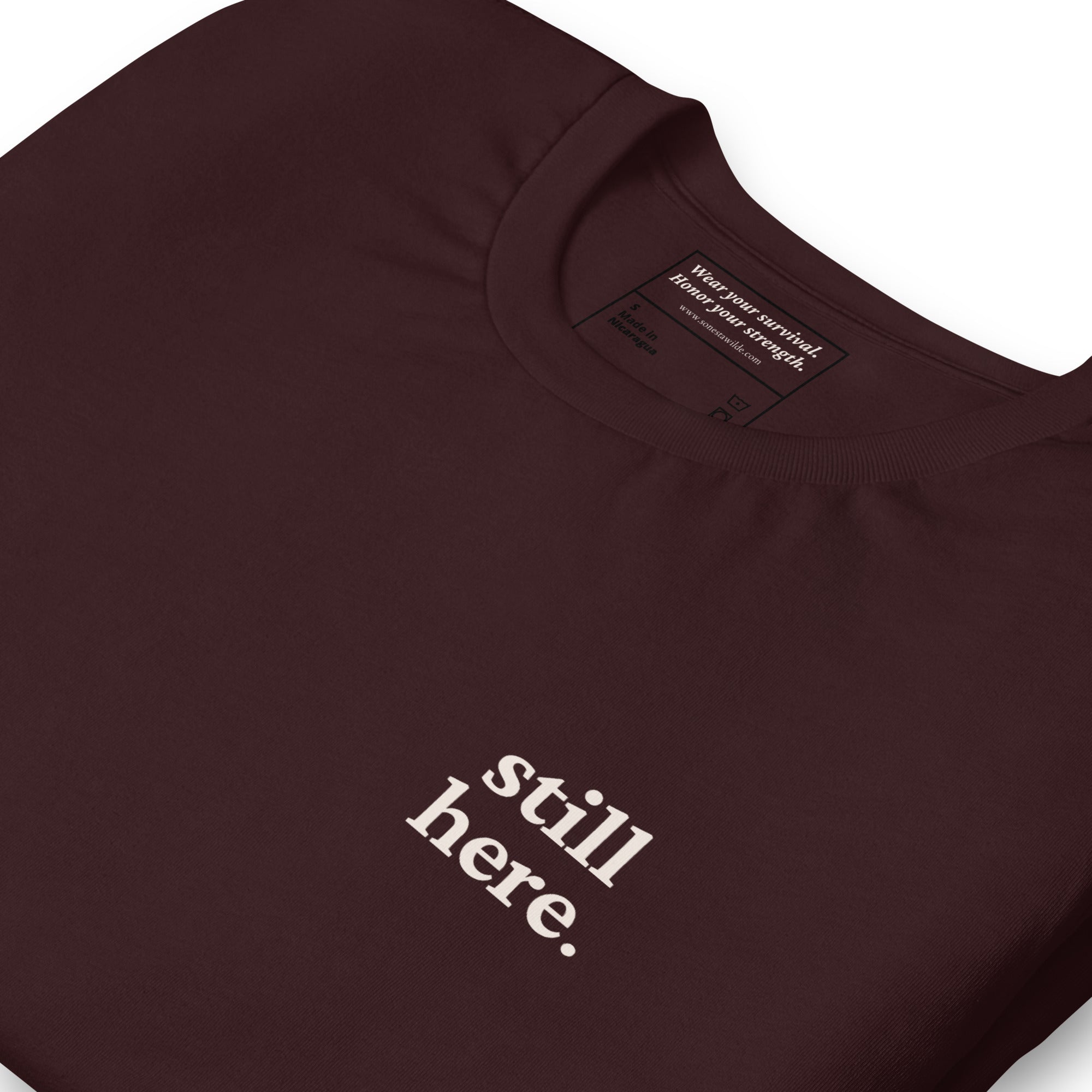 Still Here. Everyday Edition Survivor Affirmation Oxblood Black Close-Up T-Shirt