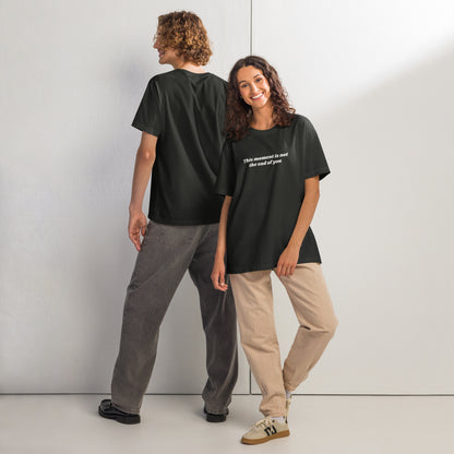 Two people wearing black t-shirts with motivational quote “This Moment Is Not the End of You” reminder affirmation for resilience and healing.