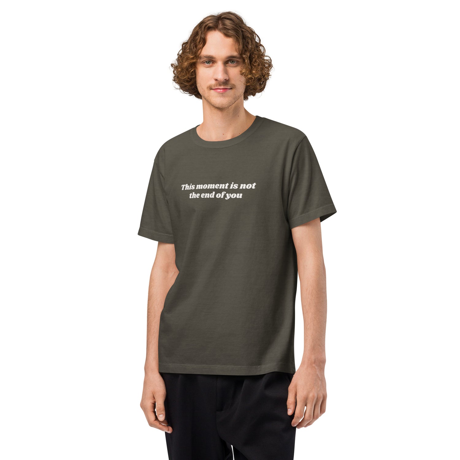 Man wearing a washed charcoal t-shirt with a motivational quote “This Moment Is Not the End of You” reminder affirmation for resilience and healing.